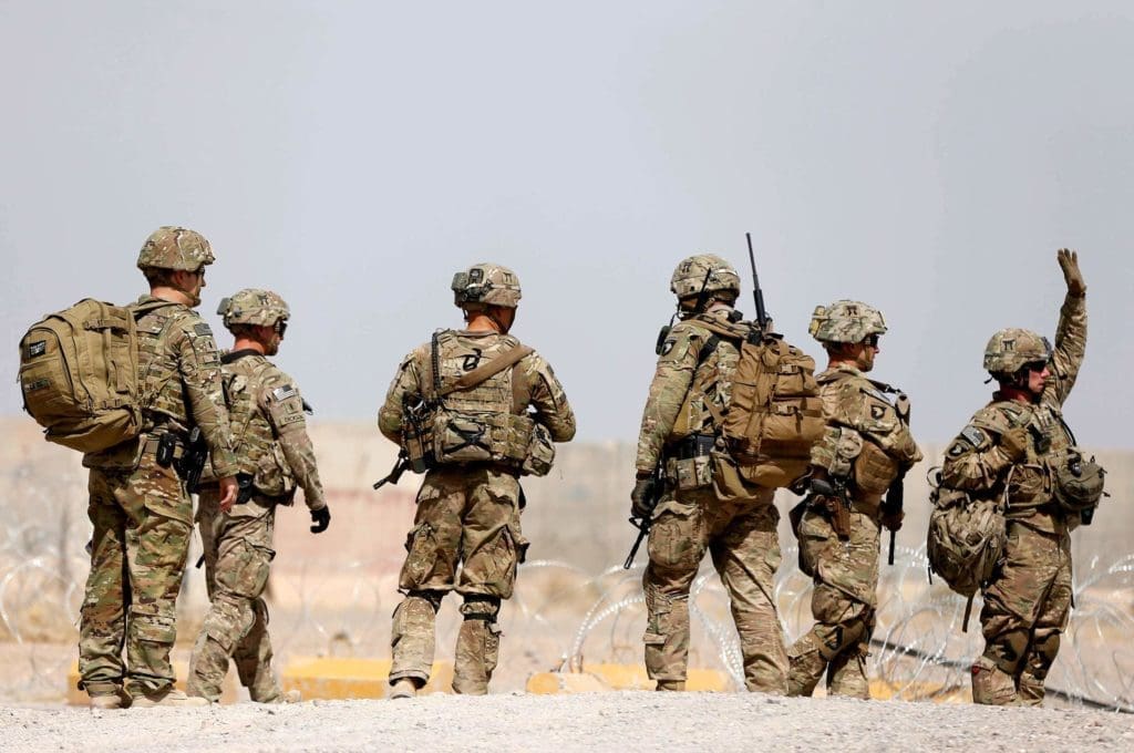 Image: FILE PHOTO: U.S. troops walk outside their base in Uruzgan province