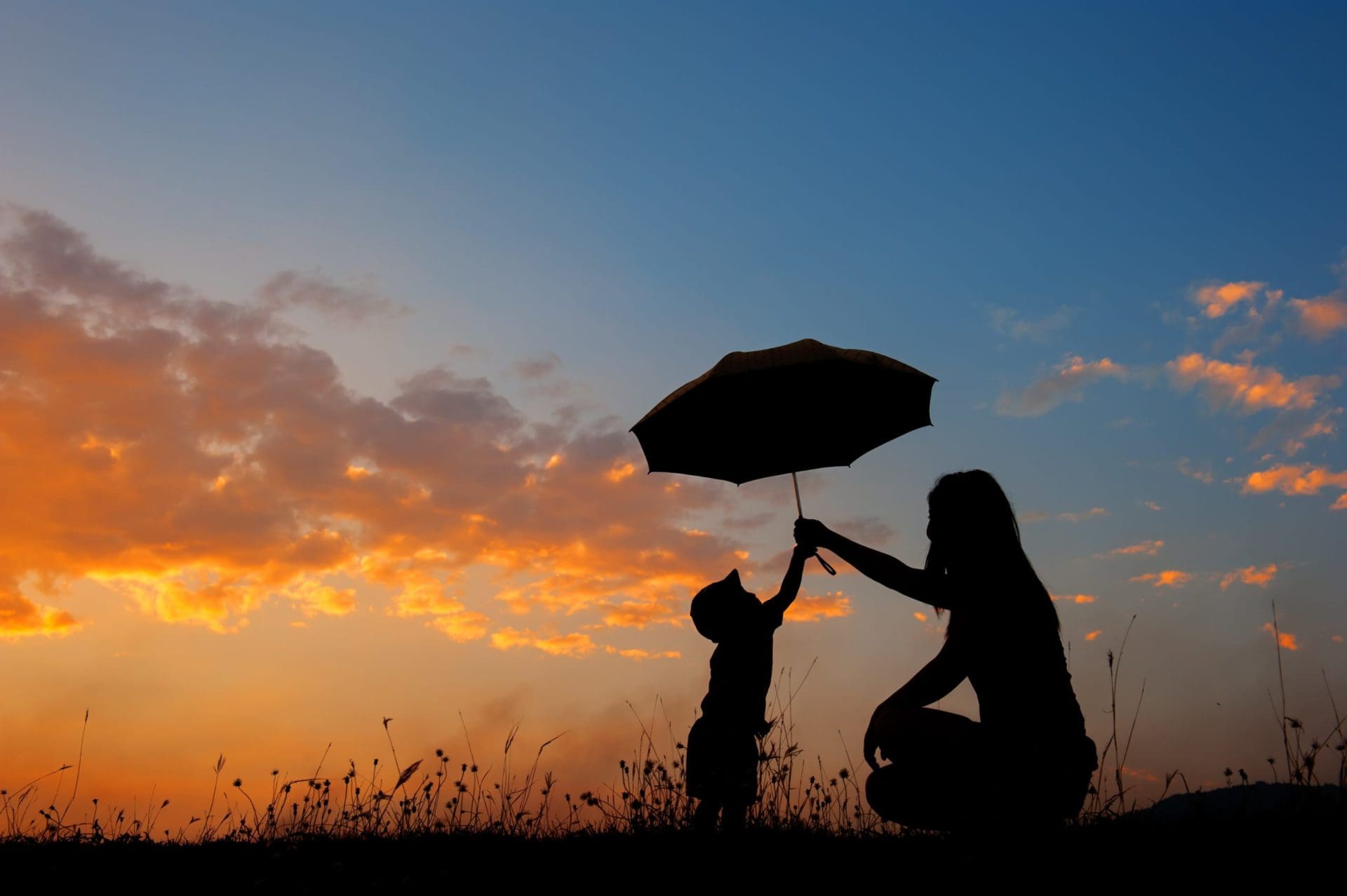 A,Mother,And,Son,Holding,Umbrella,And,Playing,Outdoors,At