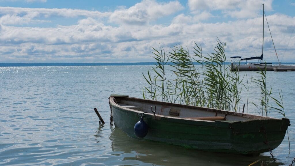 A boat and a sailing boat in the background at Lake Balaton.