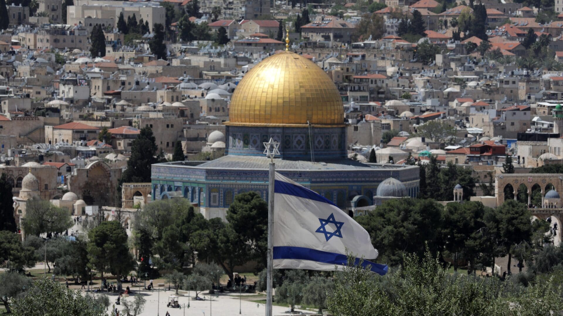 An Israeli flag with the golden dome of the Al-Aqsa mosque in the background in Jerusalem on 17 April 2023.