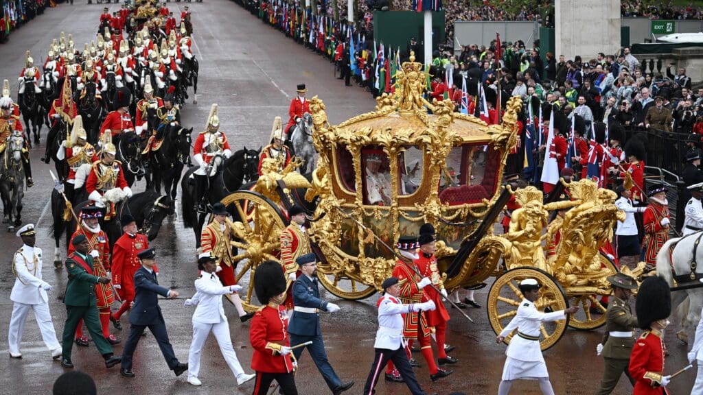 Britain's Queen Camilla and Britain's King Charles III travel in the Gold State Coach, back to Buckingham Palace from Westminster Abbey in central London on May 6, 2023, after their coronations. - The set-piece coronation is the first in Britain in 70 years, and only the second in history to be televised. Charles will be the 40th reigning monarch to be crowned at the central London church since King William I in 1066. Outside the UK, he is also king of 14 other Commonwealth countries, including Australia, Canada and New Zealand. Camilla, his second wife, was crowned alongside him, and will now be known as Queen Camilla. (Photo by Marco BERTORELLO / AFP)
