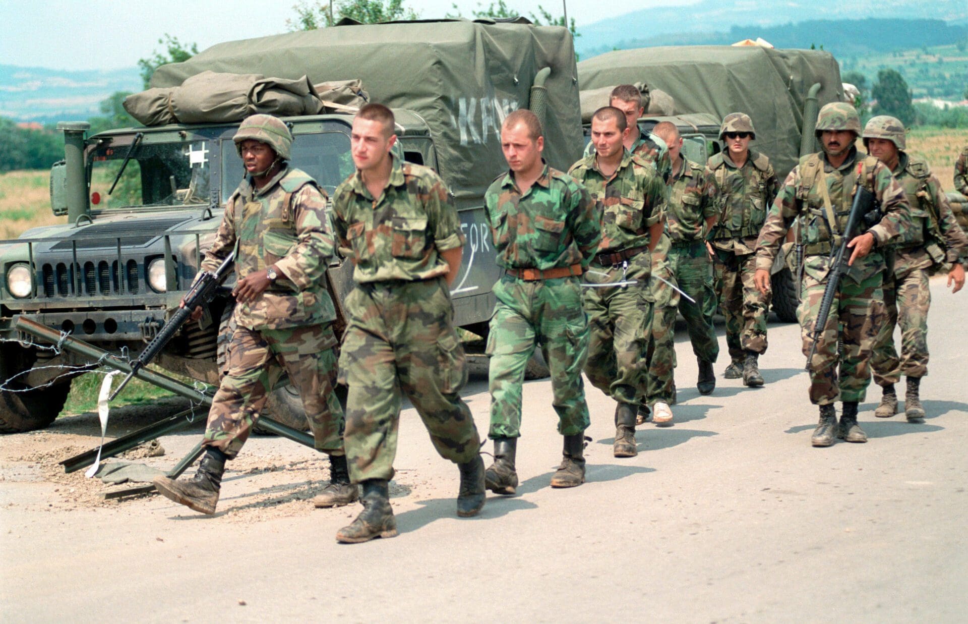 US Marines escorting Yugoslav POWs in Kosovo over to Yugoslav authorities on 3 July 1999.