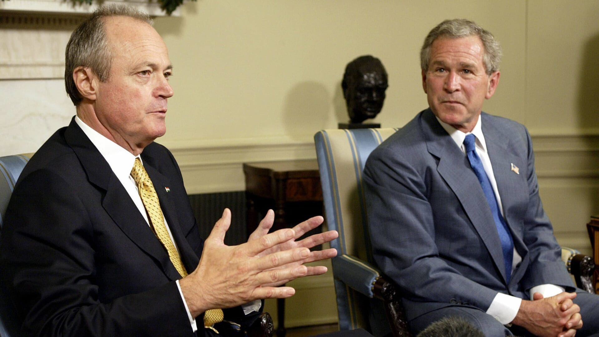 US President George W. Bush (R) listens to Hungarian Prime Minister Peter Medgyessy as he answers questions from the press after their Oval Office meeting 22 June, 2004, at the White House in Washington, DC.