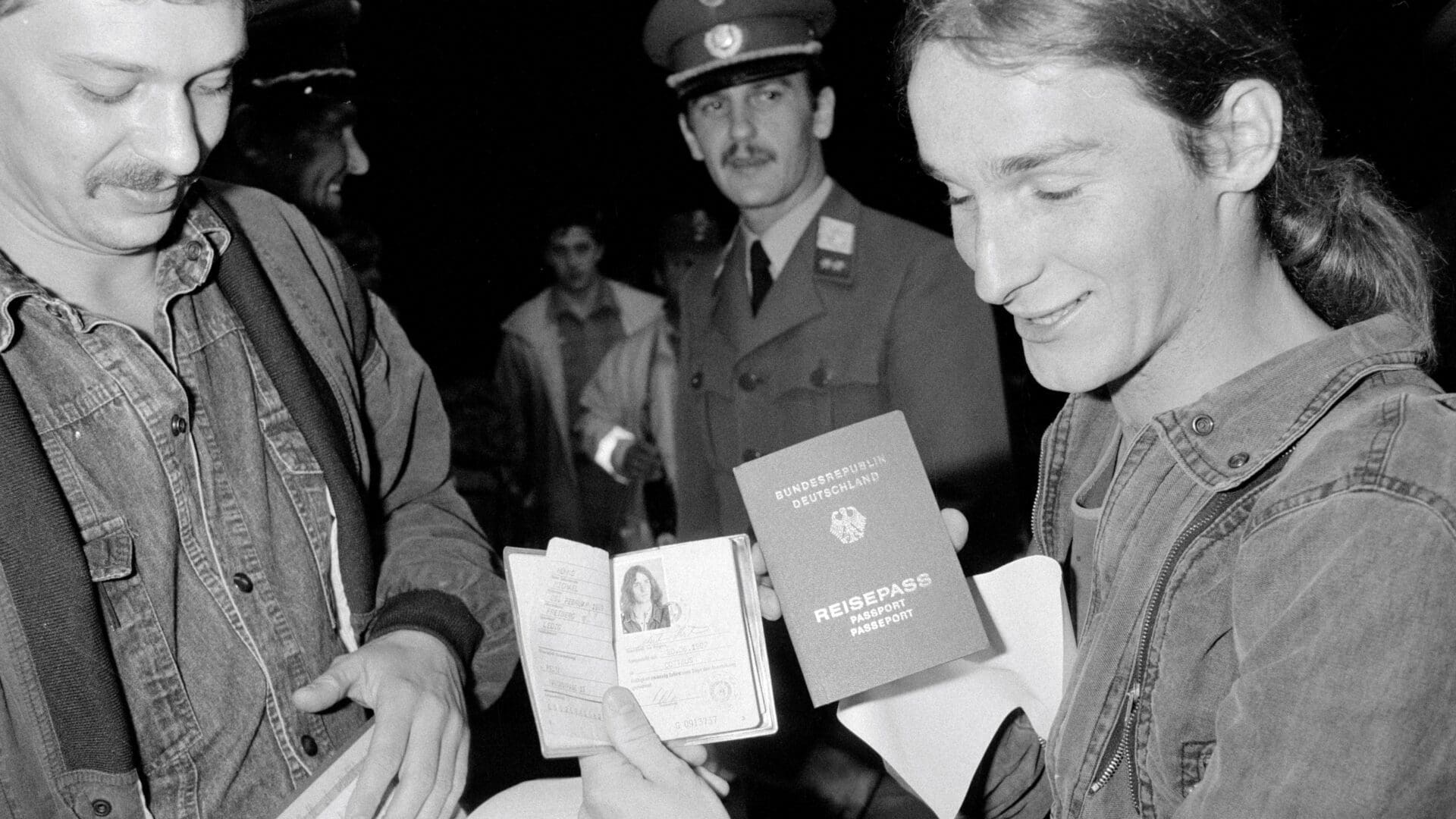 East German refugee, with a Hungarian border guard looking on, showing his documents before he is allowed to leave for West Germany through Austria.