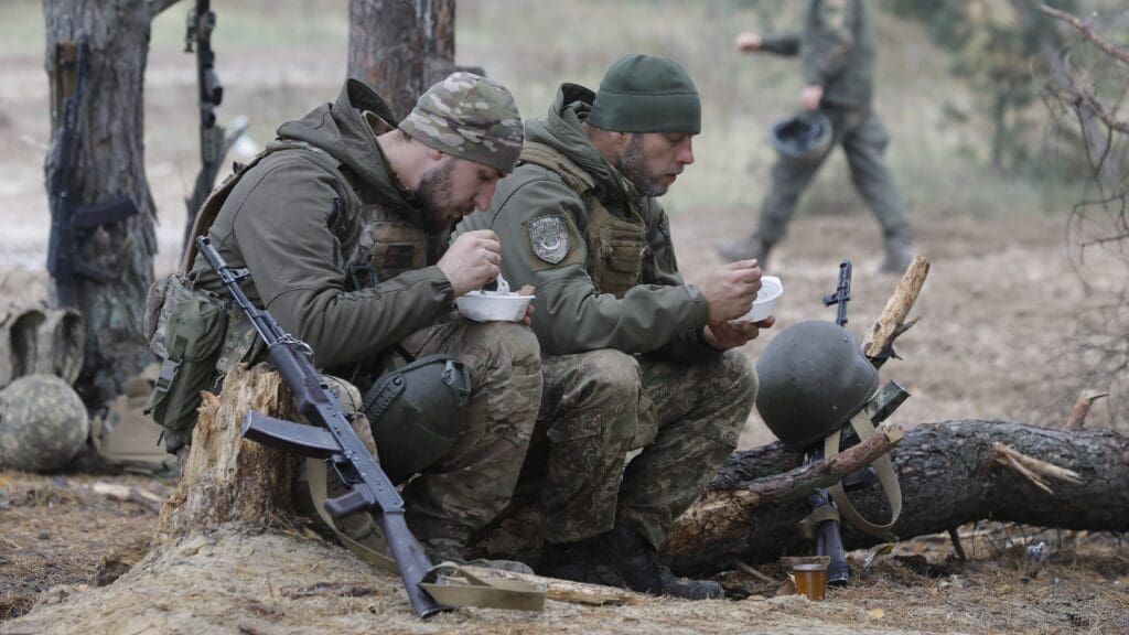 Soldiers of the Bureviy Brigade on 1 November 2023 taking their lunch break during training at a boot camp near Kyiv before starting front line service.
