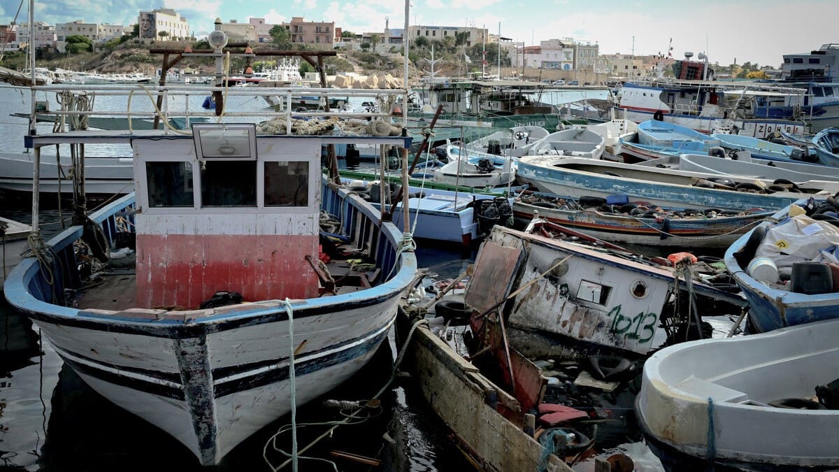 Boats used by migrants to cross the Mediterranean towed into the port of the Sicilian island of Lampedusa on 25 September 2023.