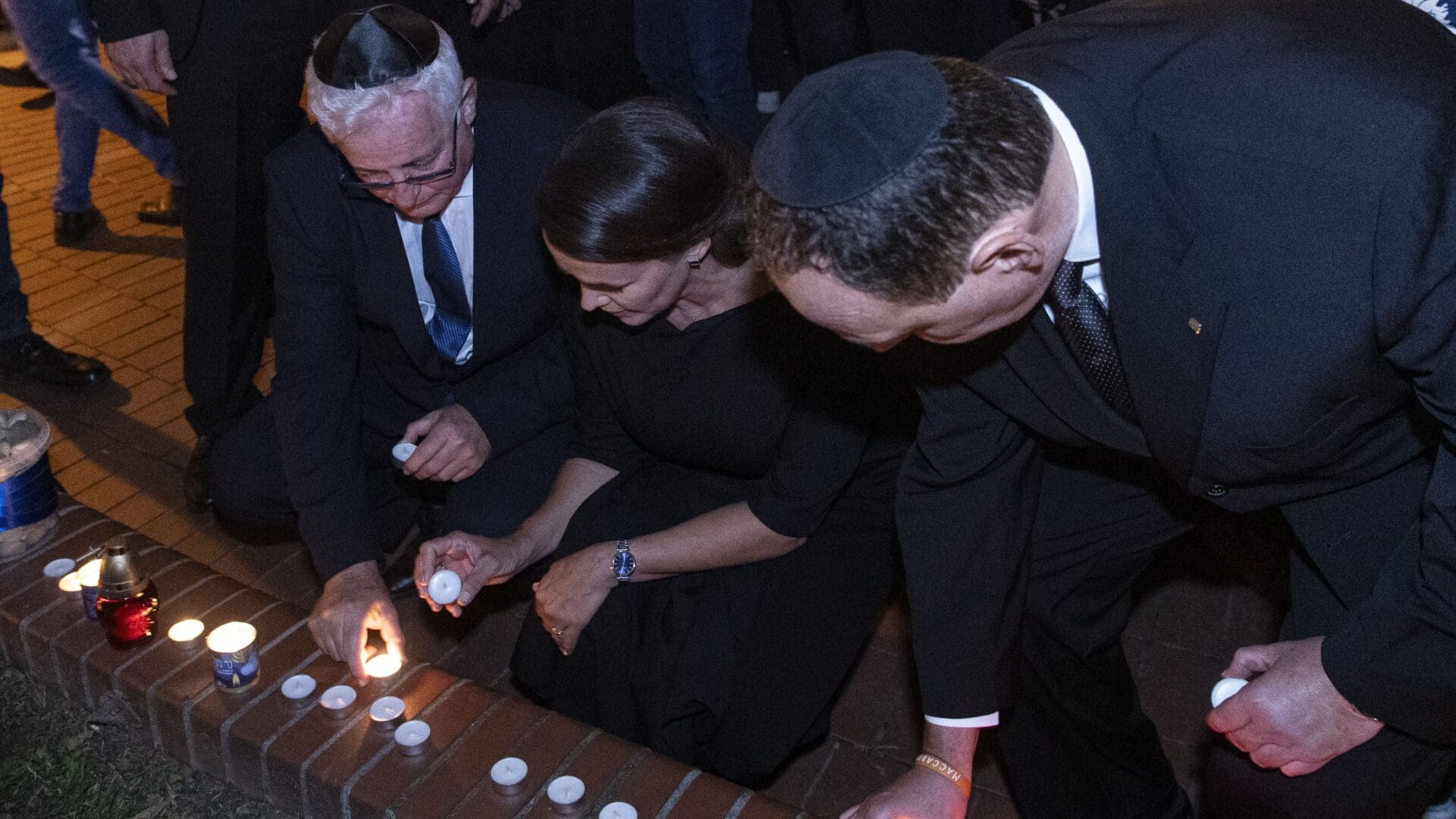 Katalin Novák, Andor Grósz (L) and President of the Budapest Jewish Religious Community Tamás Mester light candles in memory of the victims of the Hamas attack outside the Dohány Street synagogue on 11 October 2023.