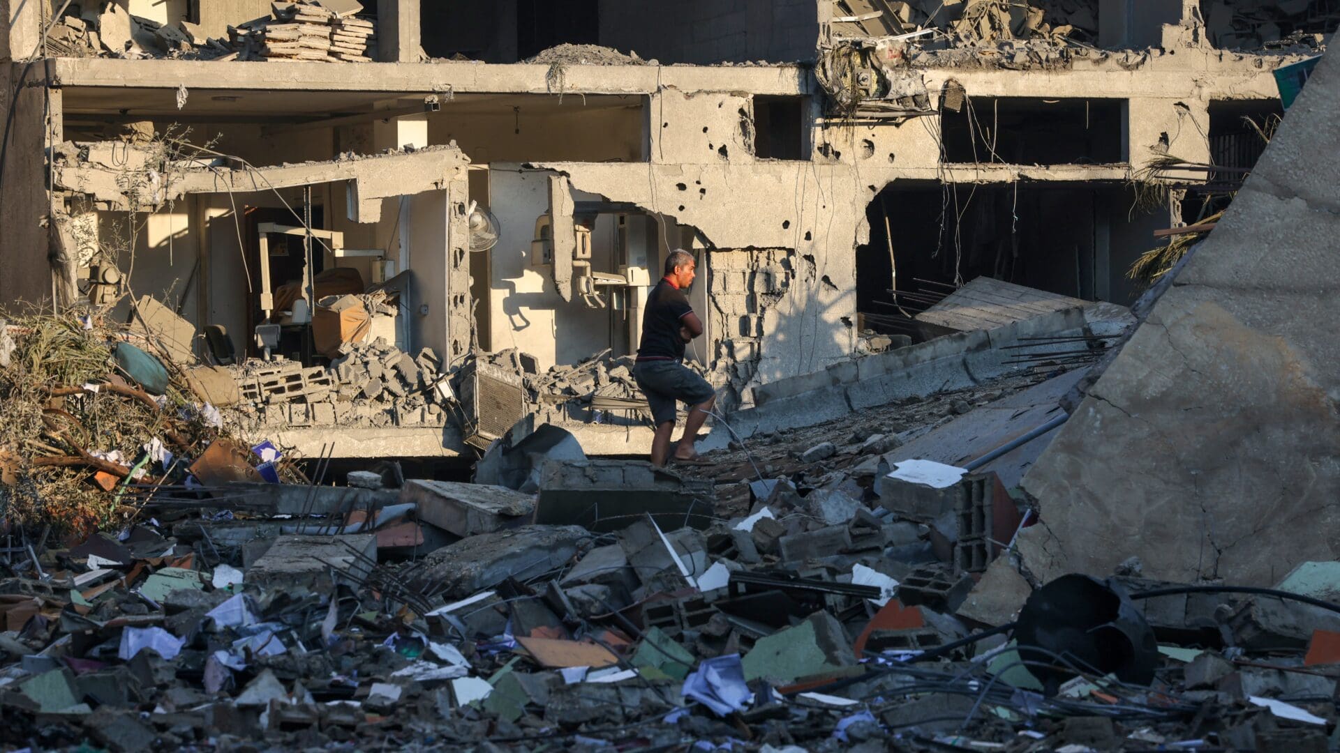 A Palestinian man walks amid the rubble of buildings destroyed during Israeli airstrikes targeting Hamas terrorists in the city of Rafah, Gaza on 16 October 2023.