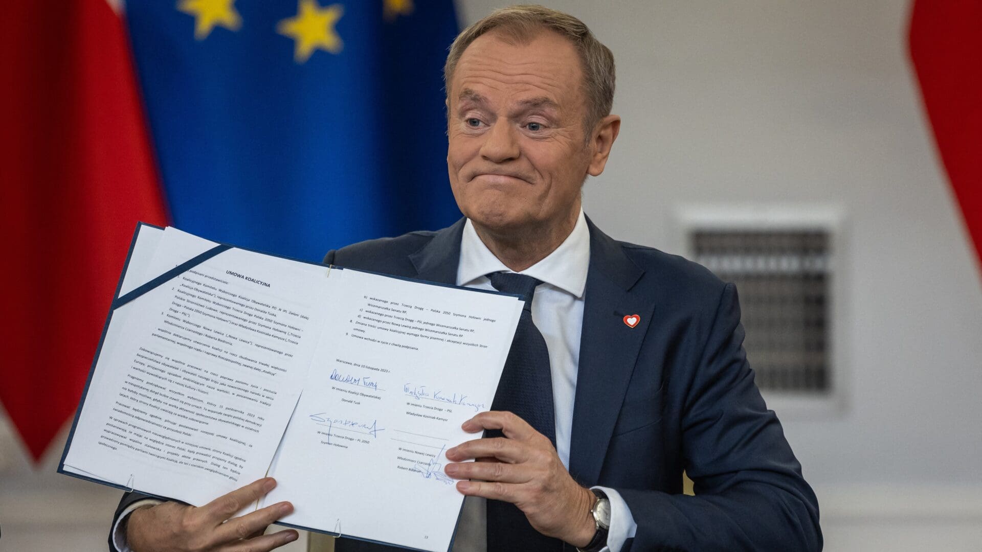 Donald Tusk poses with signed coalition agreement on 10 November 2023.