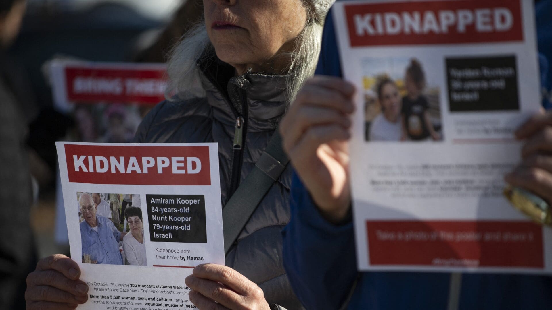 A woman holds a sign for Israelis Amiram and Nurit Kooper, taken hostage by Hamas terrorists on 12 November 2023 in Washington, D.C.