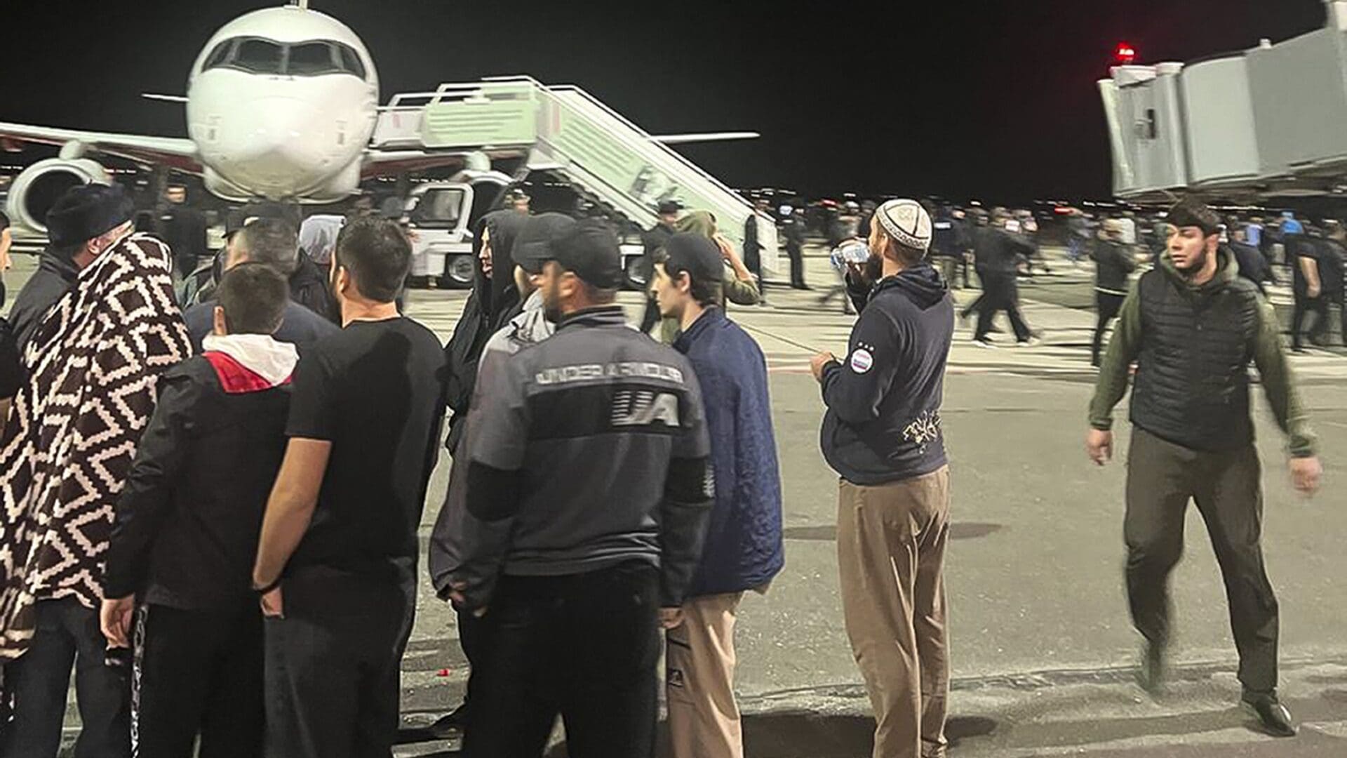 Pro-Palestinian protesters storm the runway of the Makhachkala airport in Dagestan, Russia after news that a plane from Tel Aviv had landed on 29 October 2023.