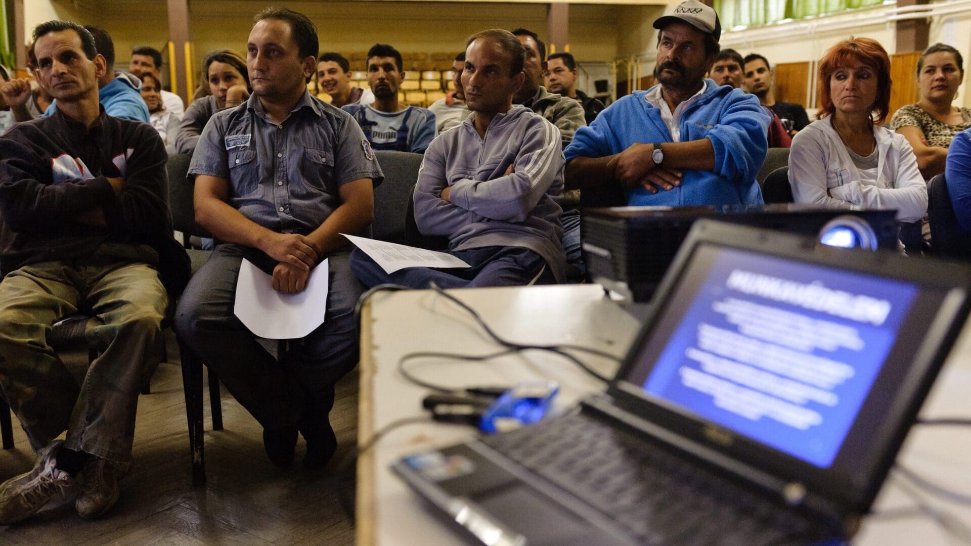 Roma public workers listen to a job safety briefing on 1 August 2011 in Gyöngyöspata, Heves County.