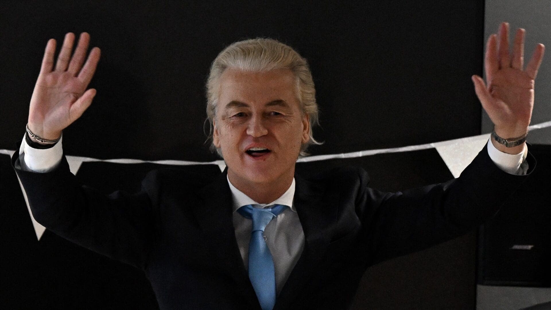 A triumphant Wilders waves waves as he arrives at a post-election meeting at the Nieuwspoort conference centre in The Hague on 23 November 2023.