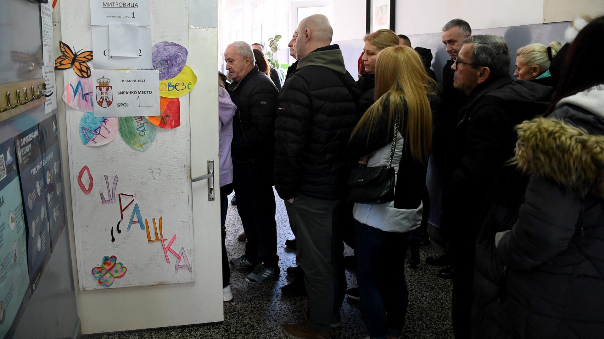 A group of Kosovo Serbs wait in a queue at a polling station in southern Serbian town of Raska, near the border with Kosovo, on 17 December 2023, during parliamentary and local elections in Serbia.