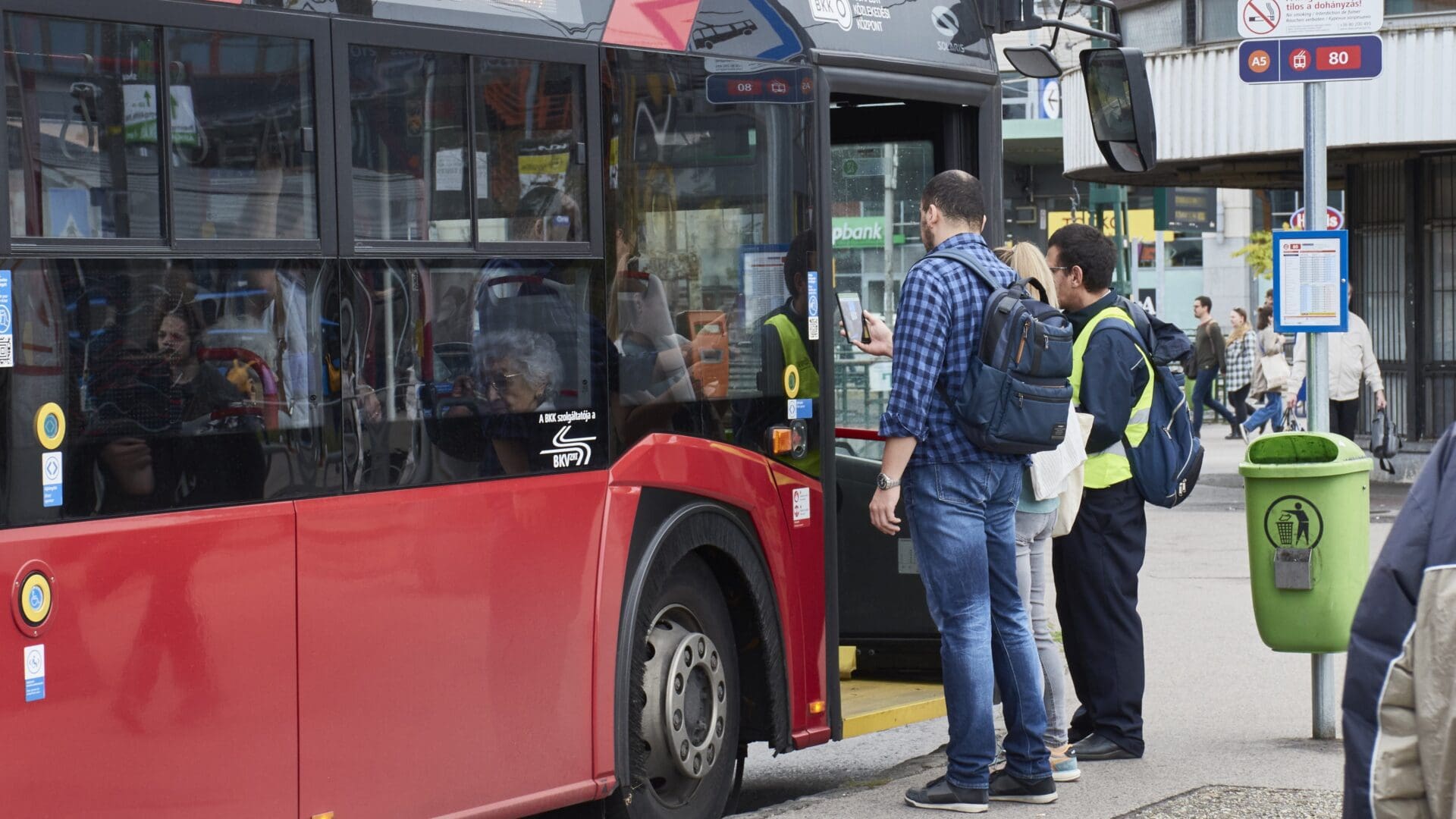 Passengers validating their mobile tickets before boarding a trolley bus in Budapest on 21 October 2023.
