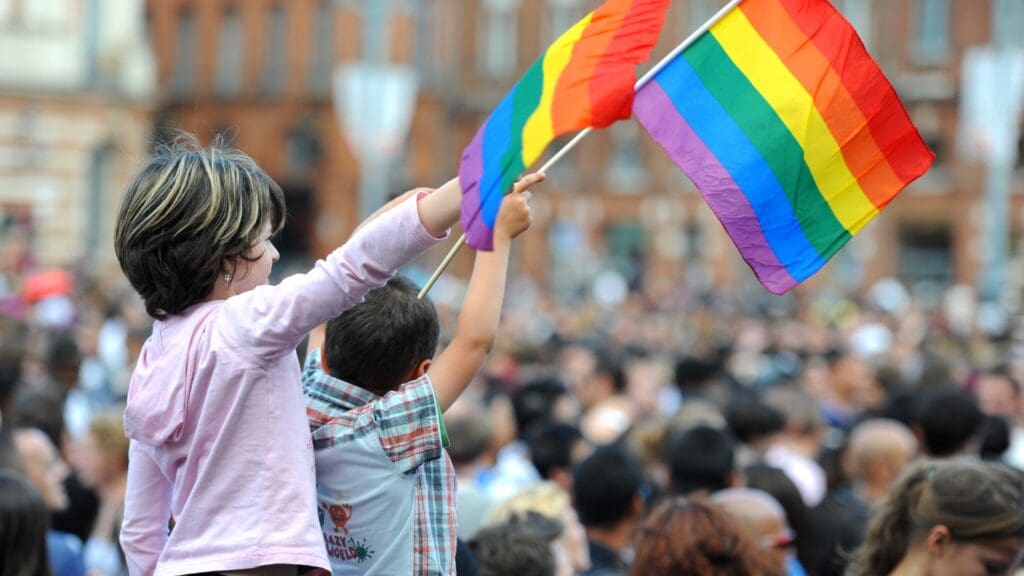 Children waving LGBT flags at the Gay Pride March in Toulouse, France in 2011.