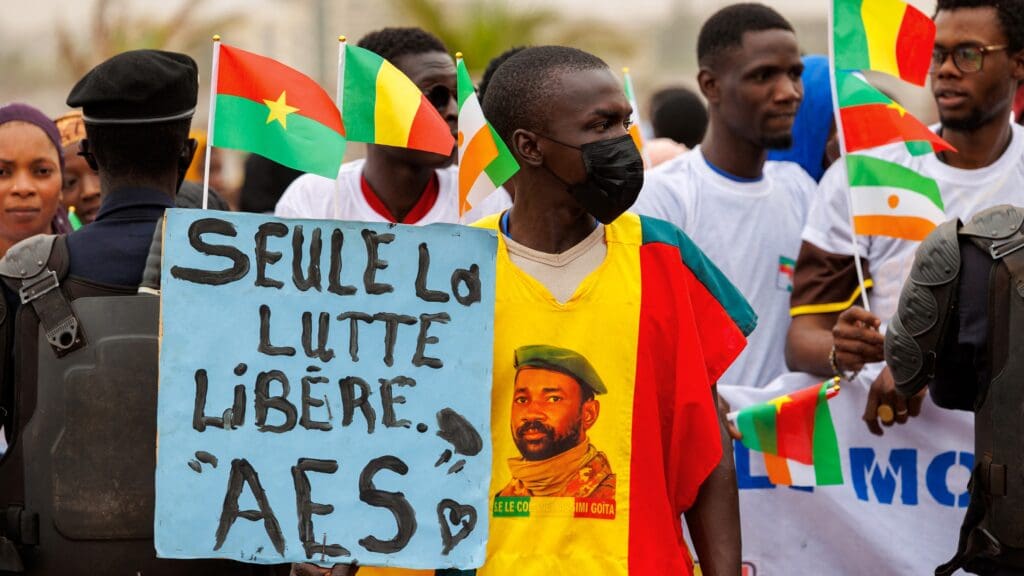 A supporter of the Alliance Of Sahel States (ASS) holds a placard reading 'only the struggle sets free' during a rally to celebrate Mali, Burkina Faso and Niger leaving the Economic Community of West African States (ECOWAS) in Bamako on 1 February 2024.