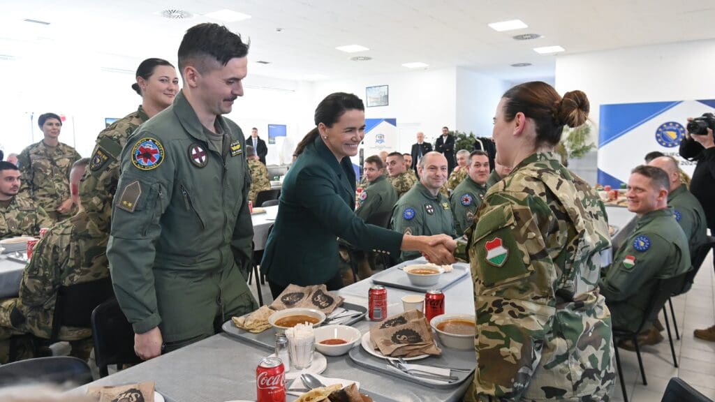 Katalin Novák shakes hands with a soldier of the Hungarian contingent serving in the EUFOR ALTHEA mission at the Butmir military base near Sarajevo on 31 January 2024.