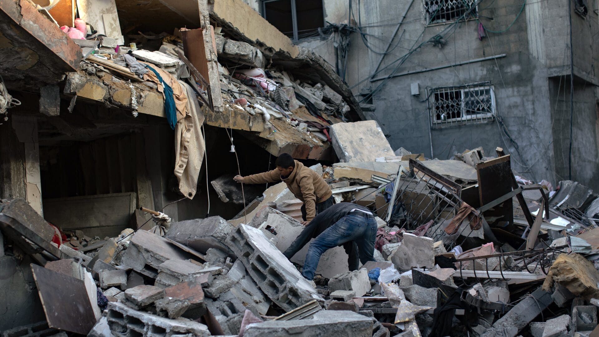 Palestinians looking for survivors under the rubble in Khan Yunis after an Israeli airstrike on 7 January 2024.