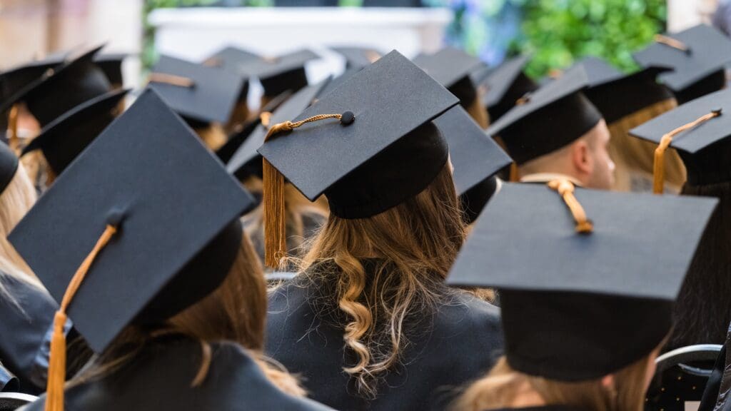 Corvinus University graduates wearing traditional caps at a graduation ceremony on 23 March 2023 in Budapest, Hungary.