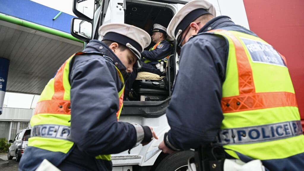 Policemen inspect a truck in Budapest as part of the European Roads Policing Network (ROADPOL) annual Truck and Bus Operation on 23 February 2024.