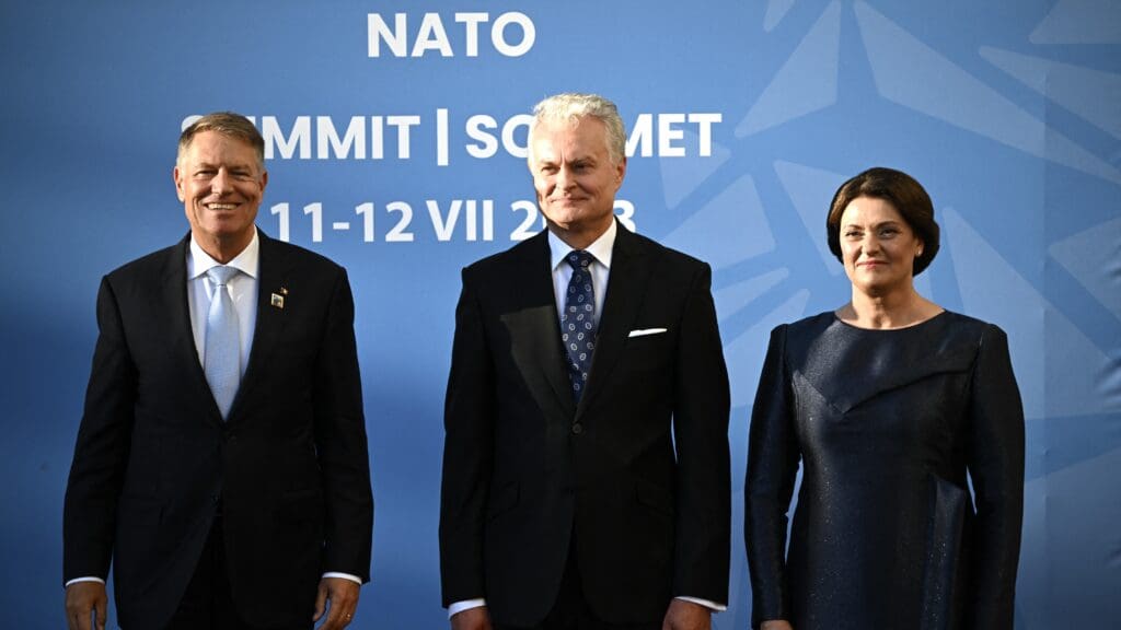 Romania's President Klaus Johannis, Lithuania's President Gitanas Nauseda and his wife Diana Nausediene pose upon arrival at the social dinner during the NATO Summit in Vilnius on 11 July 2023.