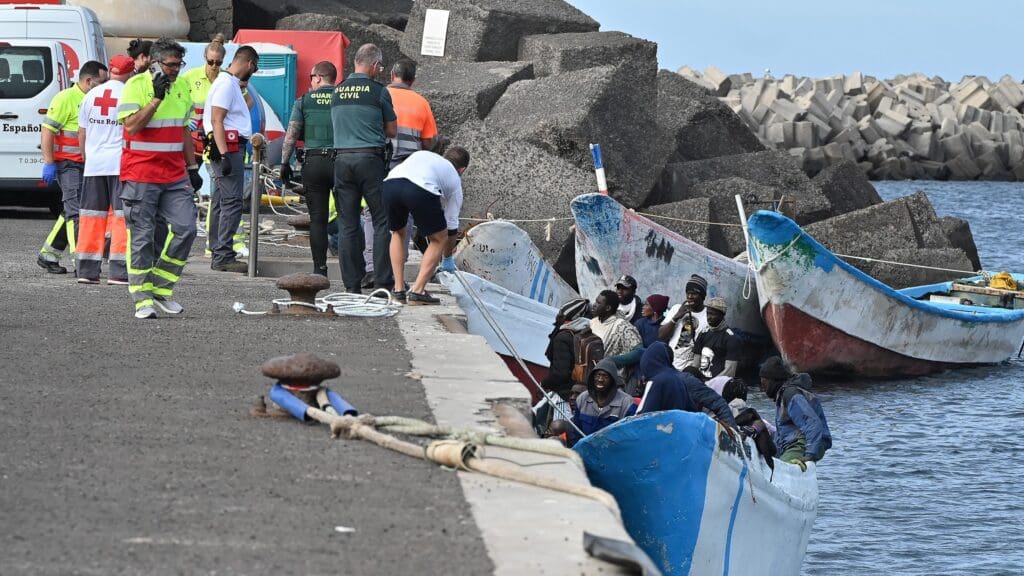 Migrants are helped off a boat by members of the Spanish Red Cross and Guardia Civil officers at La Restinga port in El Hierro, Canary Islands, Spain on 4 February 2023.