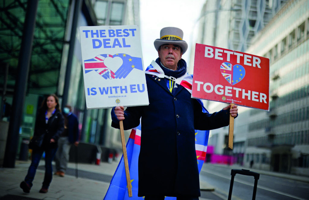 Anti-Brexit campaigner Steve Bray holds placards outside a conference centre in central London on November 9, 2020 as talks on an UK-EU trade deal continue. Britain and the European Union resumed crucial negotiations in London on Monday for a post-Brexit free trade deal, with time running short and both sides saying major obstacles remain. (Photo by Tolga Akmen / AFP)
