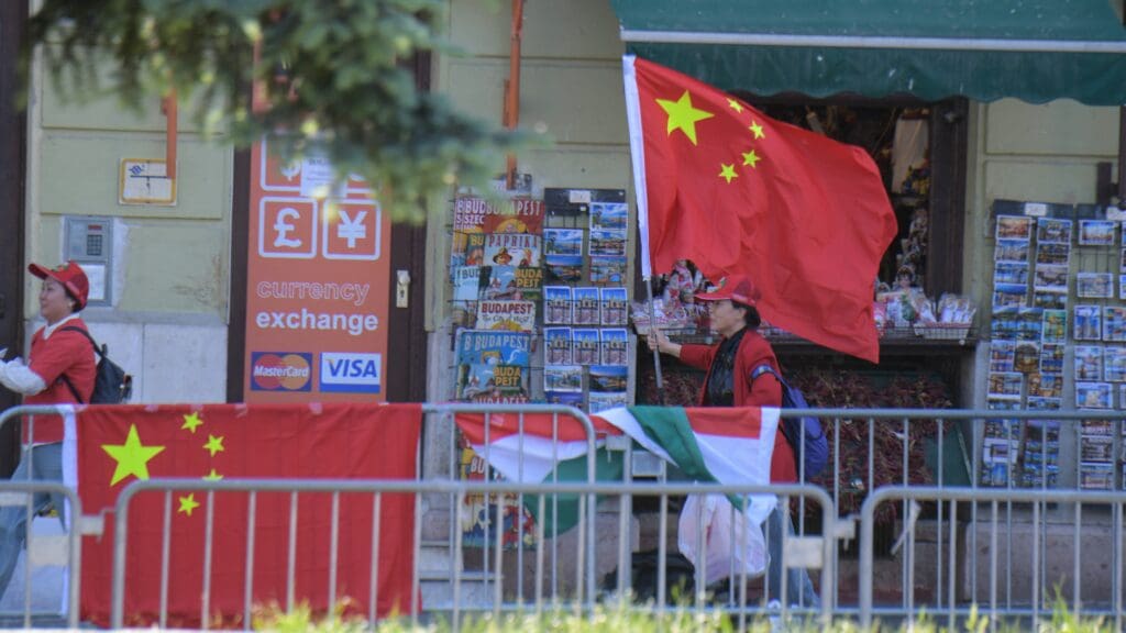 Supporters of China hold Chinese flags in the Buda Castle close to the route of Chinese President Xi Jinping’s motorcade prior to the Chinese President's meeting with Hungarian Prime Minister Viktor Orbán on 9 May 2024 in Budapest.