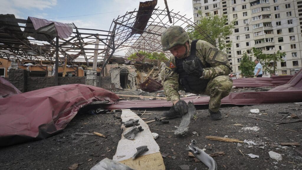 A Ukrainian EOD specialist inspects the remnants of a Russian bomb after an attack on Kharkiv on 22 May 2024.