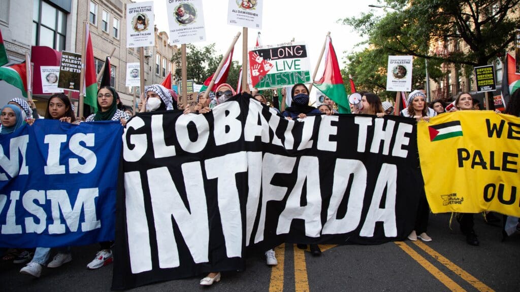 A sign reading 'Globalize The Intifada' is seen on a placard as people demonstrate in support of Palestine in Brooklyn, New York, on 31 July 2021.