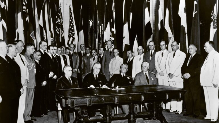 US President Franklin D. Roosevelt (second from the left) reads a statement among representatives of the United Nations during their formal pledge to cooperate for victory and adhere to the Atlantic Charter, Washington, DC, USA, 1 January 1942
