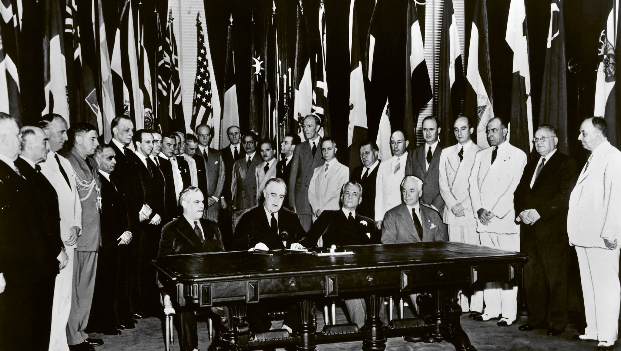 US President Franklin D. Roosevelt (second from the left) reads a statement among representatives of the United Nations during their formal pledge to cooperate for victory and adhere to the Atlantic Charter, Washington, DC, USA, 1 January 1942
