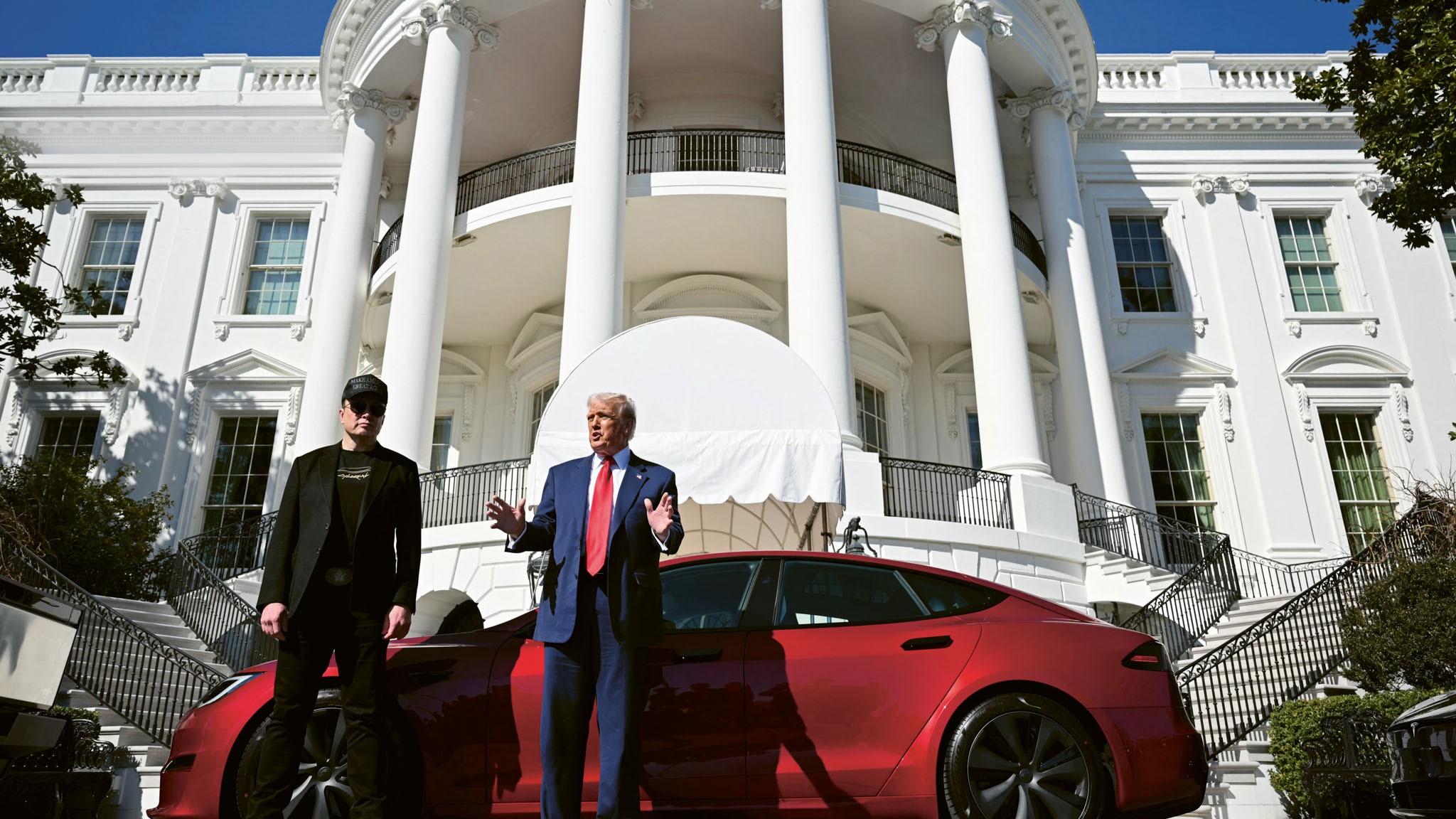 US President Donald Trump and Tesla CEO Elon Musk speak to the press as they stand next to a Tesla vehicle on the South Portico of the White House in Washington, DC, USA, 11 March 2025