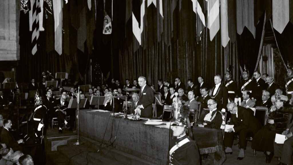 President of the Provisional Government of the French Republic Georges Bidault (standing) delivers a speech with Director-General of UNESCO Sir Julian Huxley (R) at the UNESCO conference in Paris, France, 19 November 1946