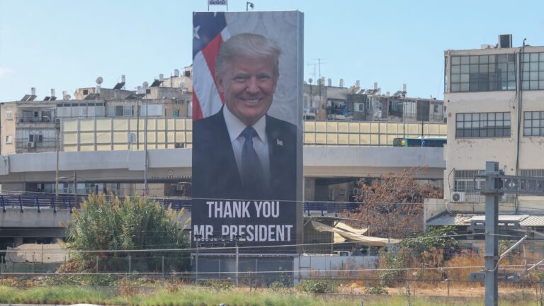 a billboard depicting US President Donald Trump in Tel Aviv on October 10, 2025