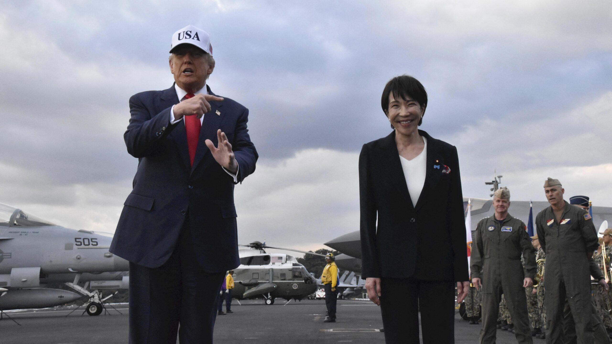 U.S. President Donald Trump (L) and Japanese Prime Minister Sanae Takaichi arrive at the nuclear-powered aircraft carrier USS George Washington (CVN-73) in Yokosuka City, Kanagawa Prefecture, Japan, on October 28, 2025