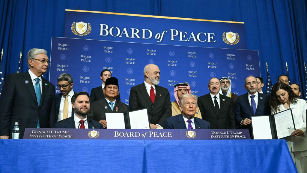 S President Donald Trump and US Vice President JD Vance sit together surrounded by members of the "Board of Peace" during a signing ceremony at the inaugural meeting of the "Board of Peace" at the US Institute of Peace in Washington, DC, on February 19, 2026.