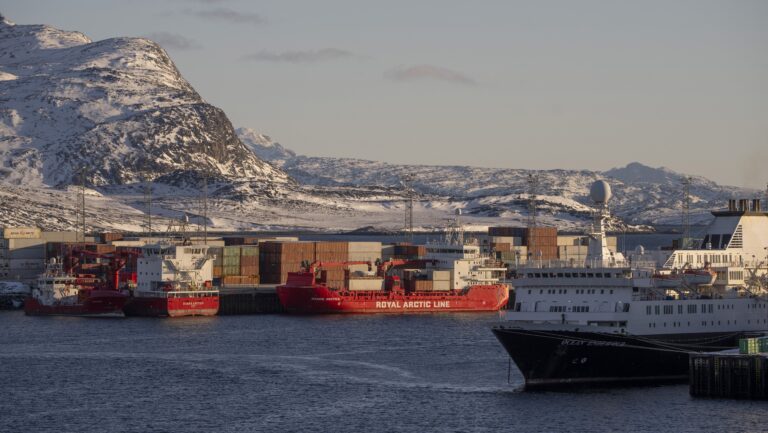 Royal Arctic Line container terminal behind Ocean Endeavour in Nuuk, Greenland